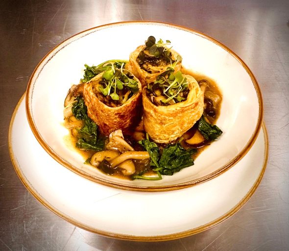 Savory crepe rolls with mushrooms and greens