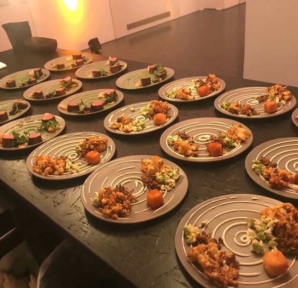 Rows of plated dishes at an event